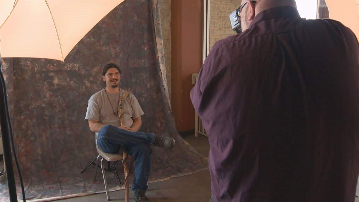 Jesse Bear getting his photograph taken by Jon Adaskin from Help-Portrait. 