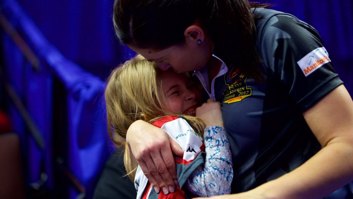 Jill Officer and her daughter Camryn share tears and a hug after the curling trials. 