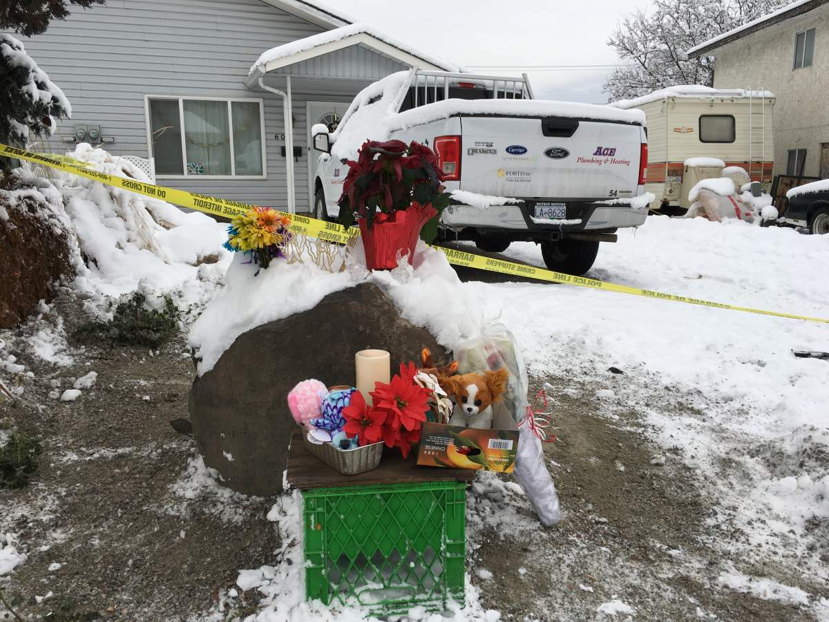 A makeshift memorial has appeared outside the home where the bodies were found.