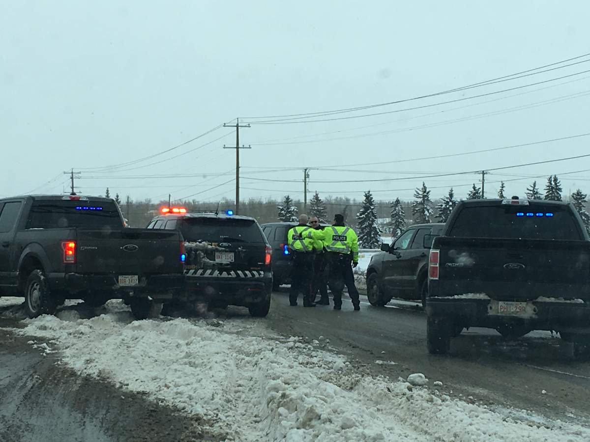 Calgary police on the scene of a crash between a garbage truck and small vehicle on Deerfoot Trail on Thursday, Dec. 21. 