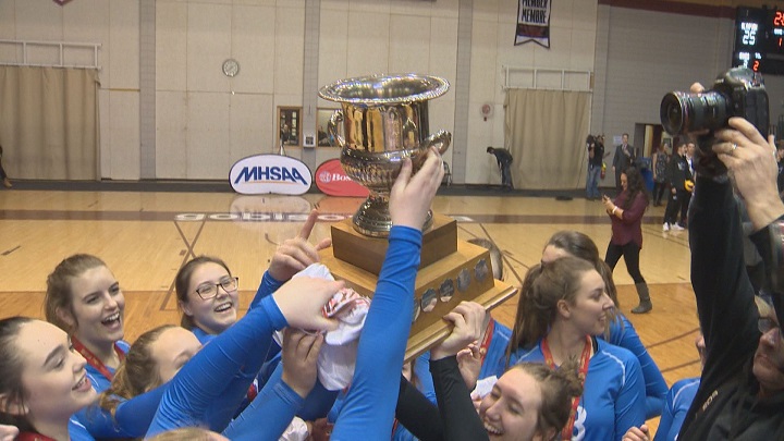 The Jeanne Sauve Olympiens celebrate their championship in girls AAAA high school volleyball.