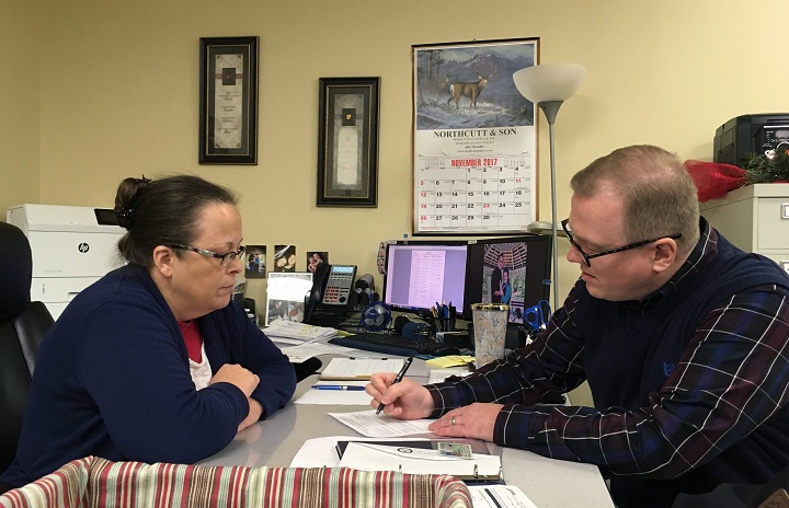 David Ermold, right, files to run for Rowan County Clerk in Kentucky as Clerk Kim Davis look on Wednesday, Dec. 6, 2017,  in Morehead, Ky. Davis denied Ermold and his husband a marriage license two years ago because she was opposed to gay marriage for religious reasons. 