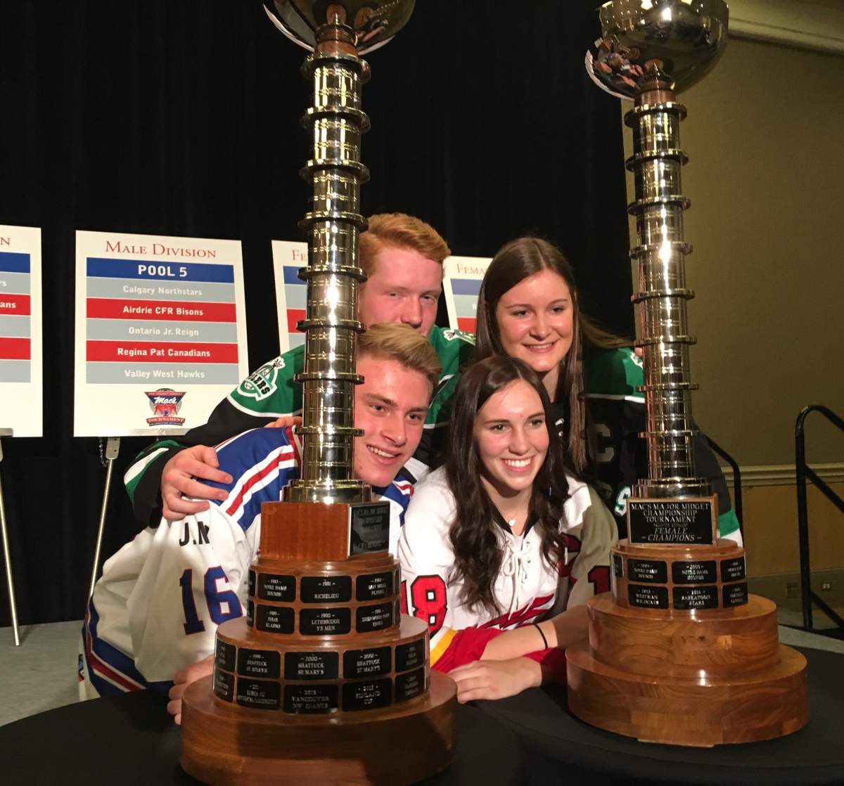 Rocky Mountain Raiders forward Laura Jardin and fellow competitors with the Mac’s Midget Hockey Tournament trophy. Westin Hotel, Calgary, Dec. 12, 2017.