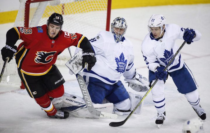 File: Toronto Maple Leafs goalie Frederik Andersen, centre, from Denmark, and teammate Nikita Zaitsev, right, from Russia, look on as Calgary Flames' Matthew Tkachuk trips over Andersen's pads during third period NHL hockey action in Calgary, Tuesday, Nov. 28, 2017. 