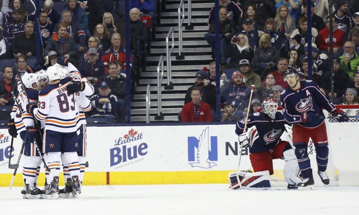 Edmonton Oilers players celebrate their goal against the Columbus Blue Jackets during the second period of an NHL hockey game Tuesday, Dec. 12, 2017, in Columbus, Ohio.