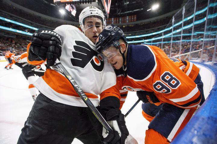 Philadelphia Flyers' Valtteri Filppula (51) and Edmonton Oilers' Jesse Puljujarvi (98) battle in the corner during second period NHL action in Edmonton, Alta., on Wednesday December 6, 2017. 