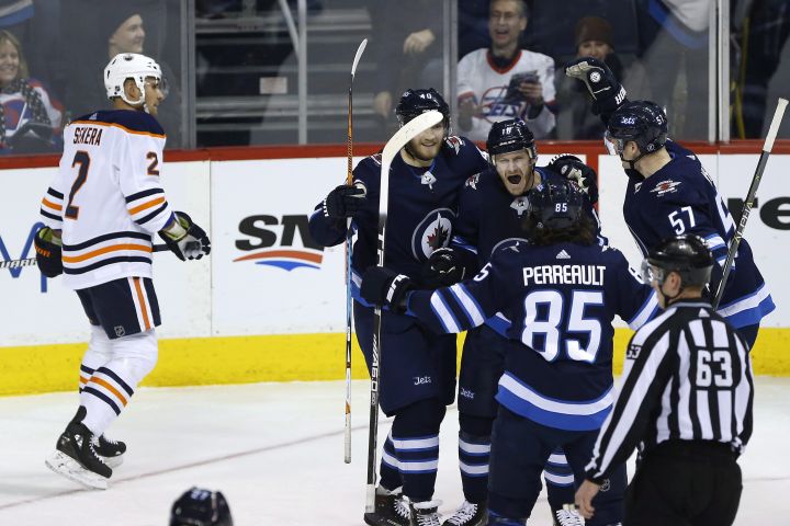 Winnipeg Jets' Joel Armia (40), Mathieu Perreault (85), Bryan Little (18) and Tyler Myers (57) celebrate Little's goal as Edmonton Oilers' Andrej Sekera (2) looks on during the first period NHL action in Winnipeg on Wednesday, December 27, 2017. 