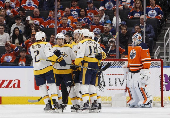 Nashville Predators players celebrate a goal as Edmonton Oilers goalie Laurent Brossoit (1) looks on during second period NHL action in Edmonton, Alta., on Thursday December 14, 2017. 