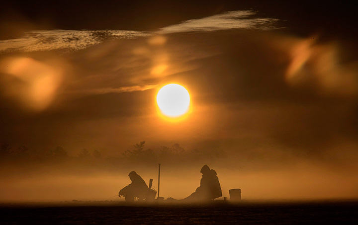 Morning sun greets ice fisherman on Pigeon Lake, in the Kawartha’s region of central Ontario on February 19, 2017.