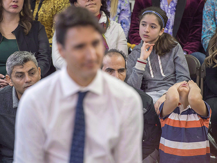 A young boy attends a town hall meeting with Prime Minister Justin Trudeau during a visit to the Cultural Centre in Fredericton, Jan. 17, 2017. 