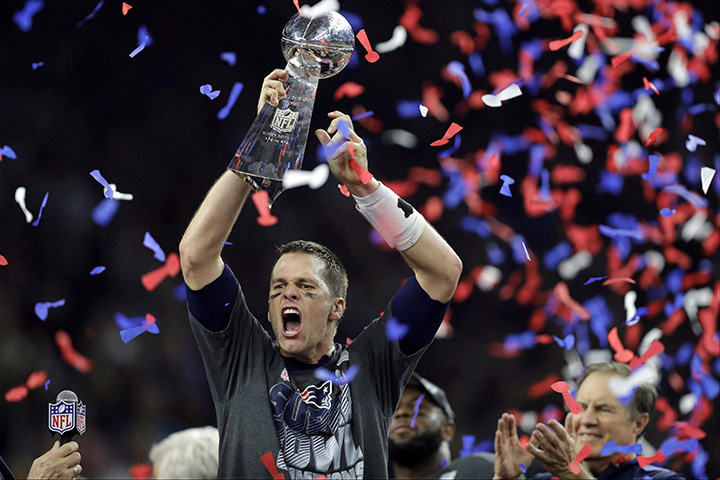 New England Patriots' Tom Brady raises the Vince Lombardi Trophy after defeating the Atlanta Falcons in overtime to win Super Bowl 51 on Feb. 5, 2017, in Houston. 