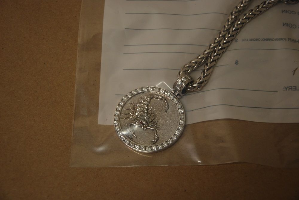 A picture of a medallion showing a scorpion that was attached to an RCMP news release about the arrest of, and charges against, Red Scorpions associates in Kamloops on Dec. 11, 2017.