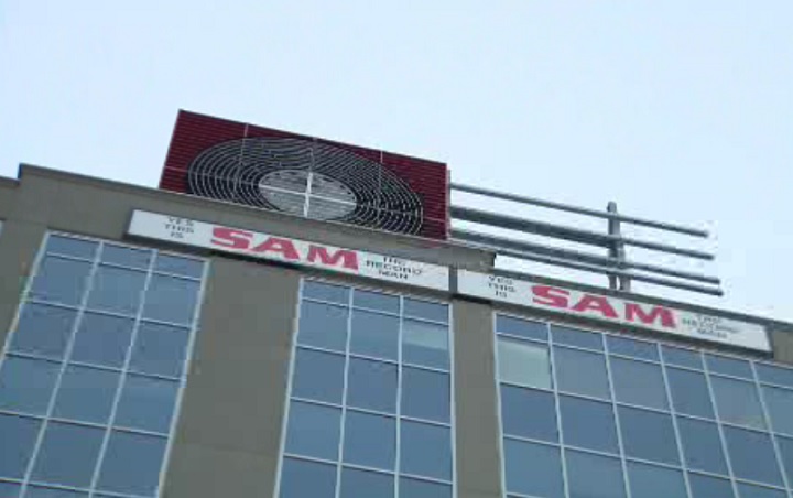 The Sam the Record Man sign is being installed at Yonge-Dundas Square on Dec. 1, 2017.