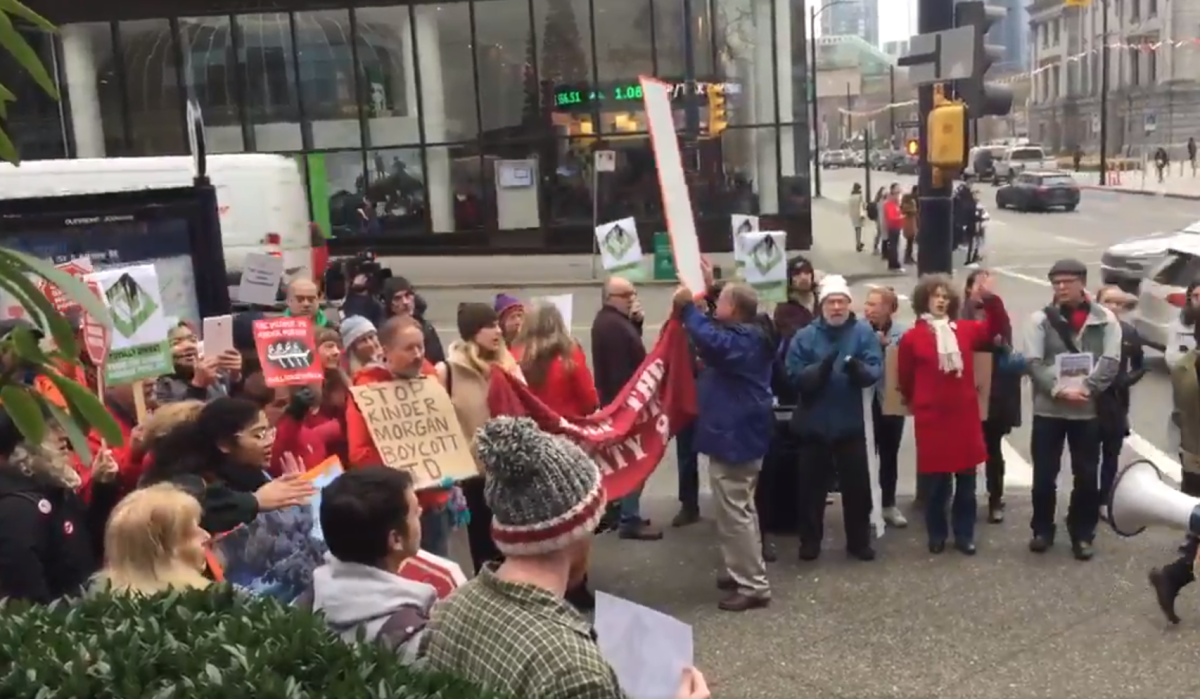 Protesters in front of the TD tower in Vancouver rally against the Trans Mountain Pipeline expansion.