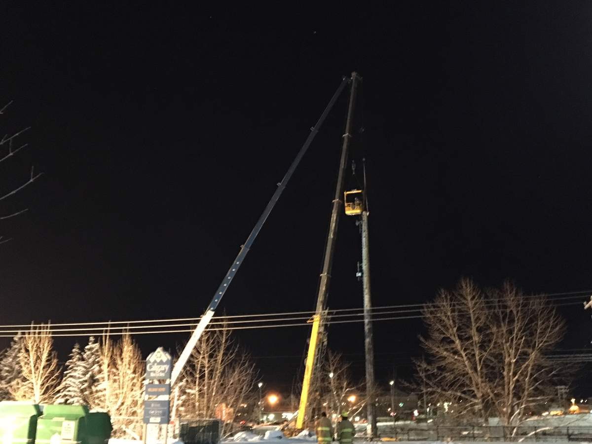 A repair crew works to secure the top of a tower that was at risk of falling onto CTrain tracks on Wednesday, Dec. 20.
