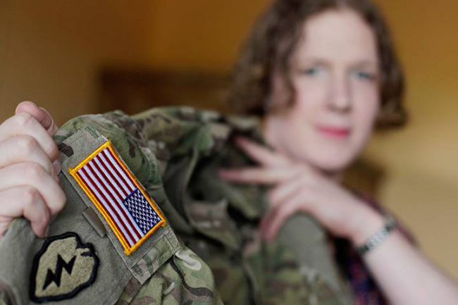In this July 29, 2017 photo, transgender U.S. army captain Jennifer Sims lifts her uniform during an interview with The Associated Press in Beratzhausen near Regensburg, Germany. 