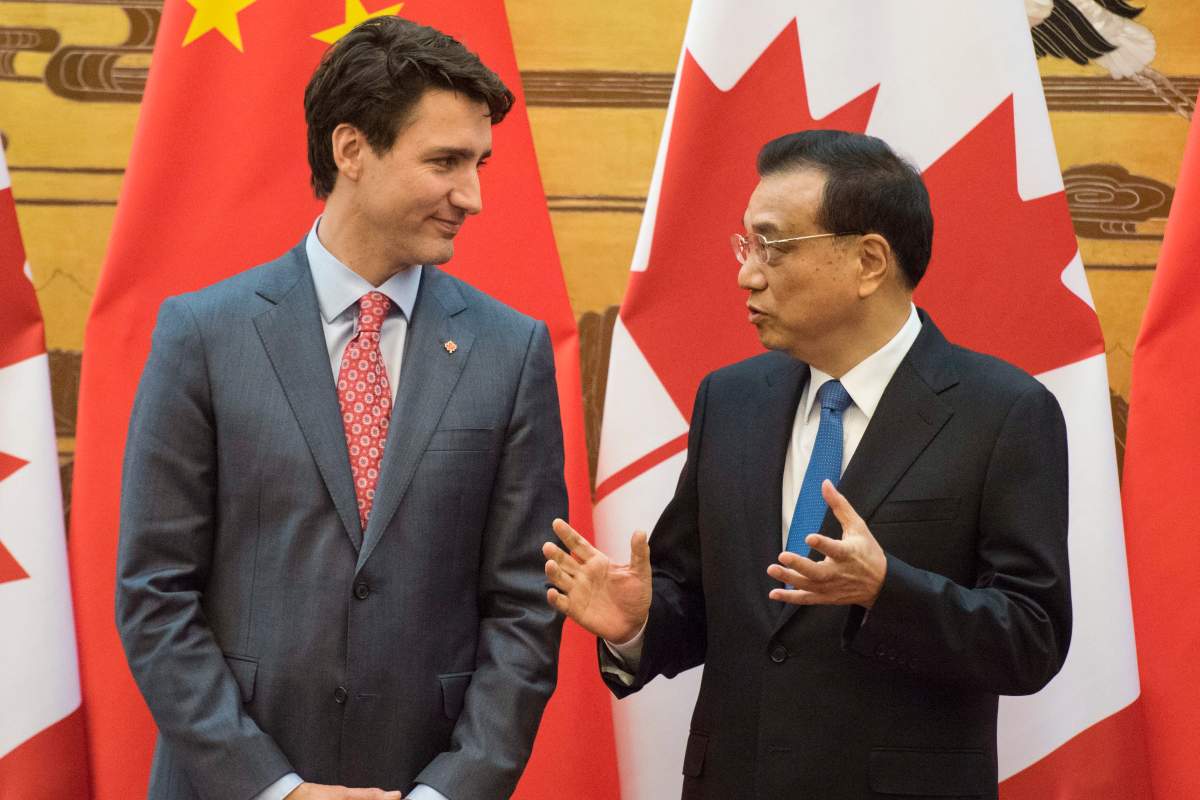 Prime Minister Justin Trudeau and Chinese Premier Li Keqiang speak during a signing ceremony at the Great Hall of the People in Beijing Monday, Dec. 4, 2017. 