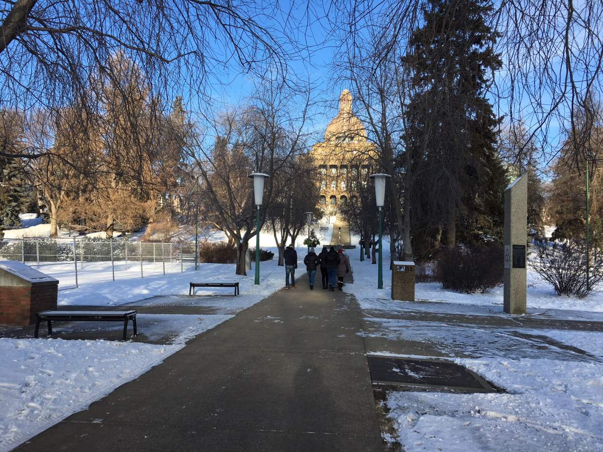 A family entertaining their Australian guests by taking them on a guided tour of the Legislature.
