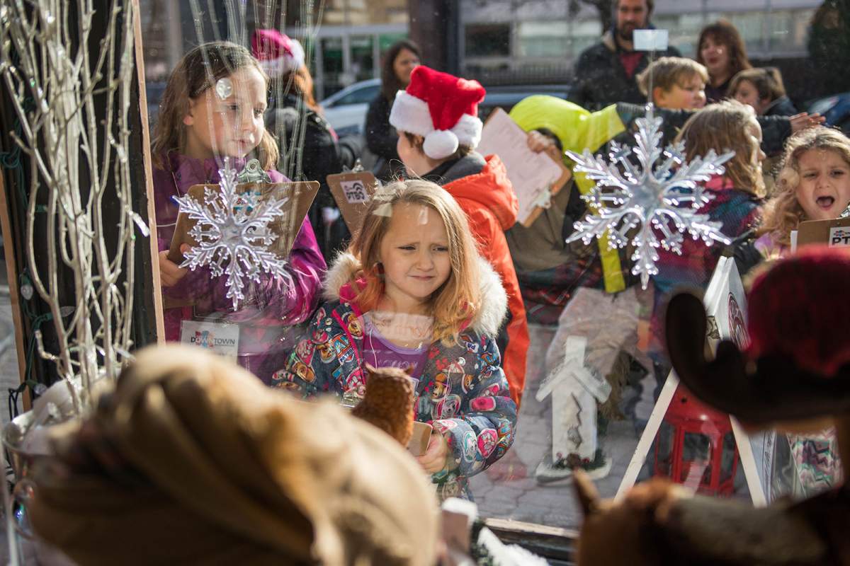 Judges from Big Brothers Big Sisters in Peterborough review downtown holiday storefronts. Joel Wiebe/DBIA