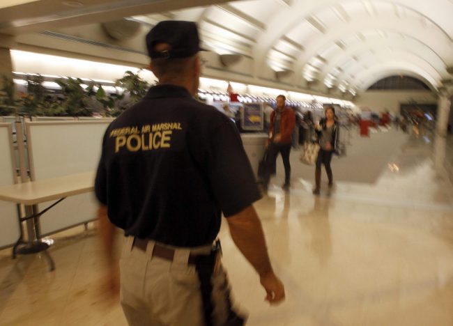A federal air marshal walks through a check-in area at John Wayne Orange County Airport in Santa Ana, Calif., Sept. 11, 2011.