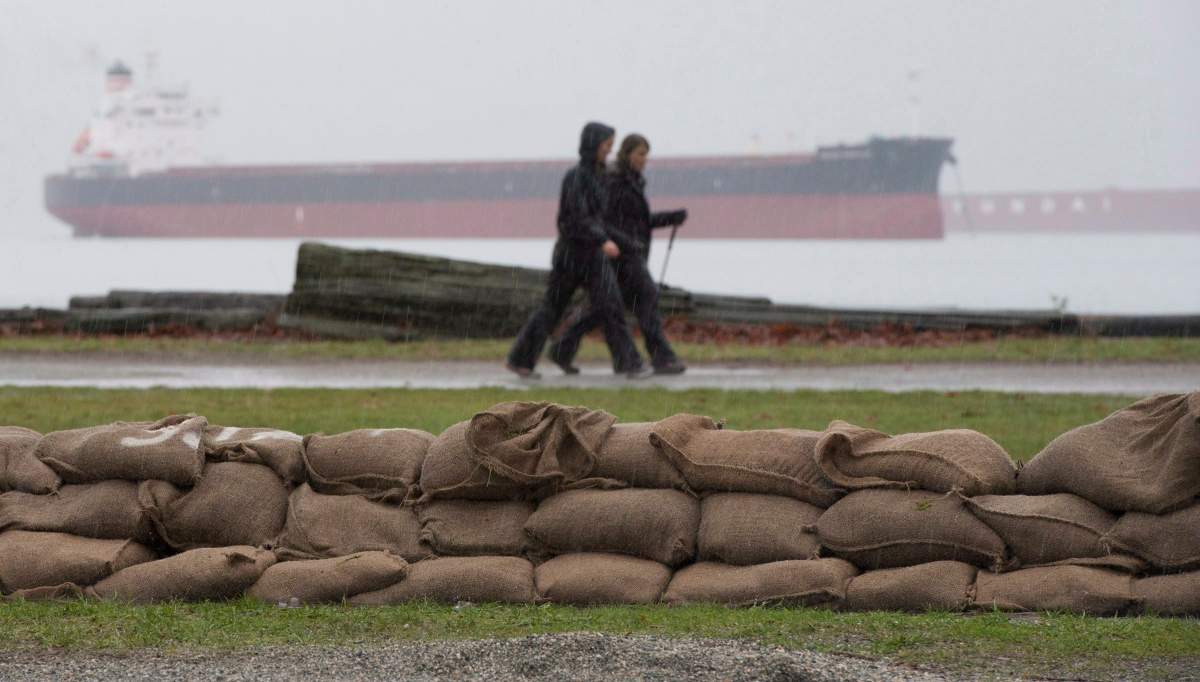 Sandbags are placed along the shores of Locarno Beach in Vancouver, Wednesday Dec. 10, 2014 in anticipation of a king tide.