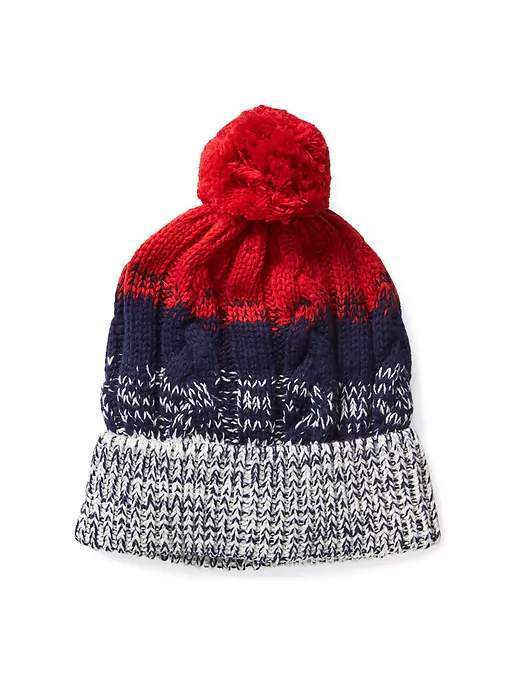 An all-red winter hat may be too much for some, so this striped alternative from the Gap offers a compromise. Each cable-knit hat is made with cotton, wool and includes a pom on the top.