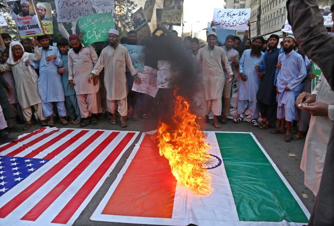 Supporters of Hafiz Saeed, the founder of the banned Islamic charity Jamat ud Dawa (JuD), burn mock flages of India and the USA as they shout slogans after the government placed him under house arrest, in Karachi, Pakistan, 10 February 2017.