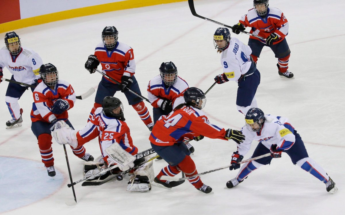 In this April 6, 2017 file photo, South Korea's Lee Eun-ji, bottom right, scores a goal as North Korea's Kim Kum Bok, bottom second right, tries to block the puck during their IIHF Ice Hockey Women's World Championship Division II Group A game in Gangneung, South Korea. 
