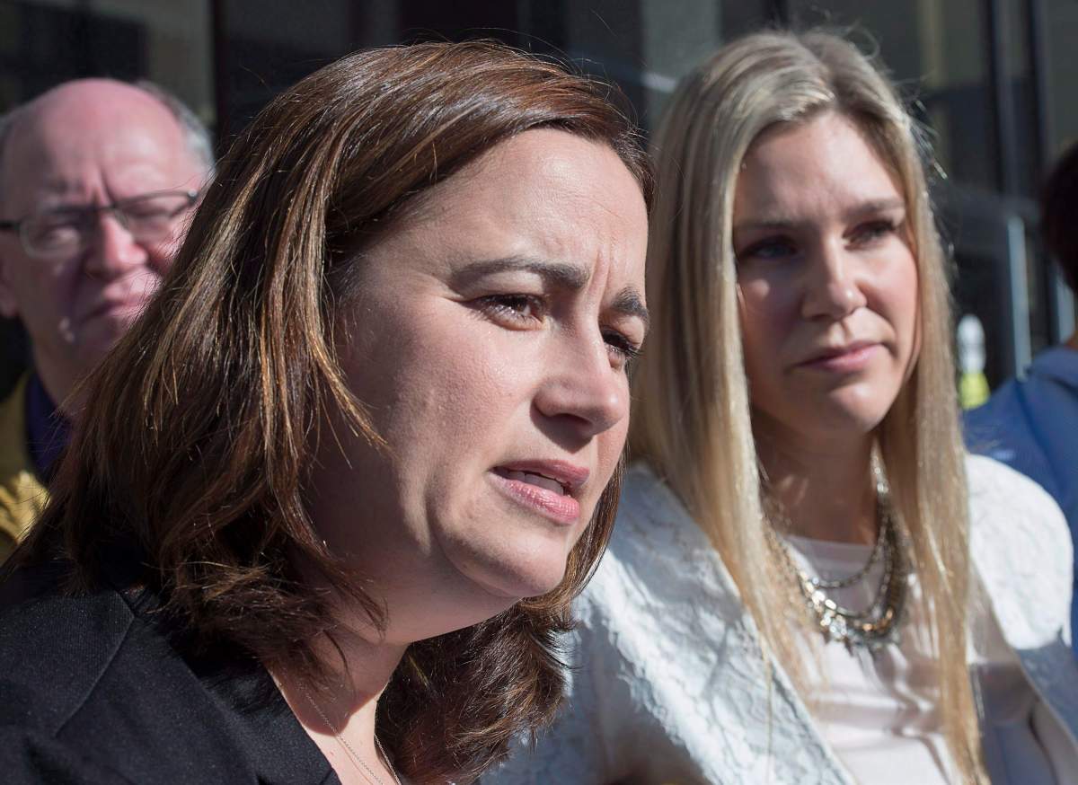 Nadine Larche, left, wife of Const. Doug Larche and Rachael Ross, wife of Const. Dave Ross, talk with reporters at the Law Courts in Moncton, N.B. on Friday, Sept. 29, 2017. 