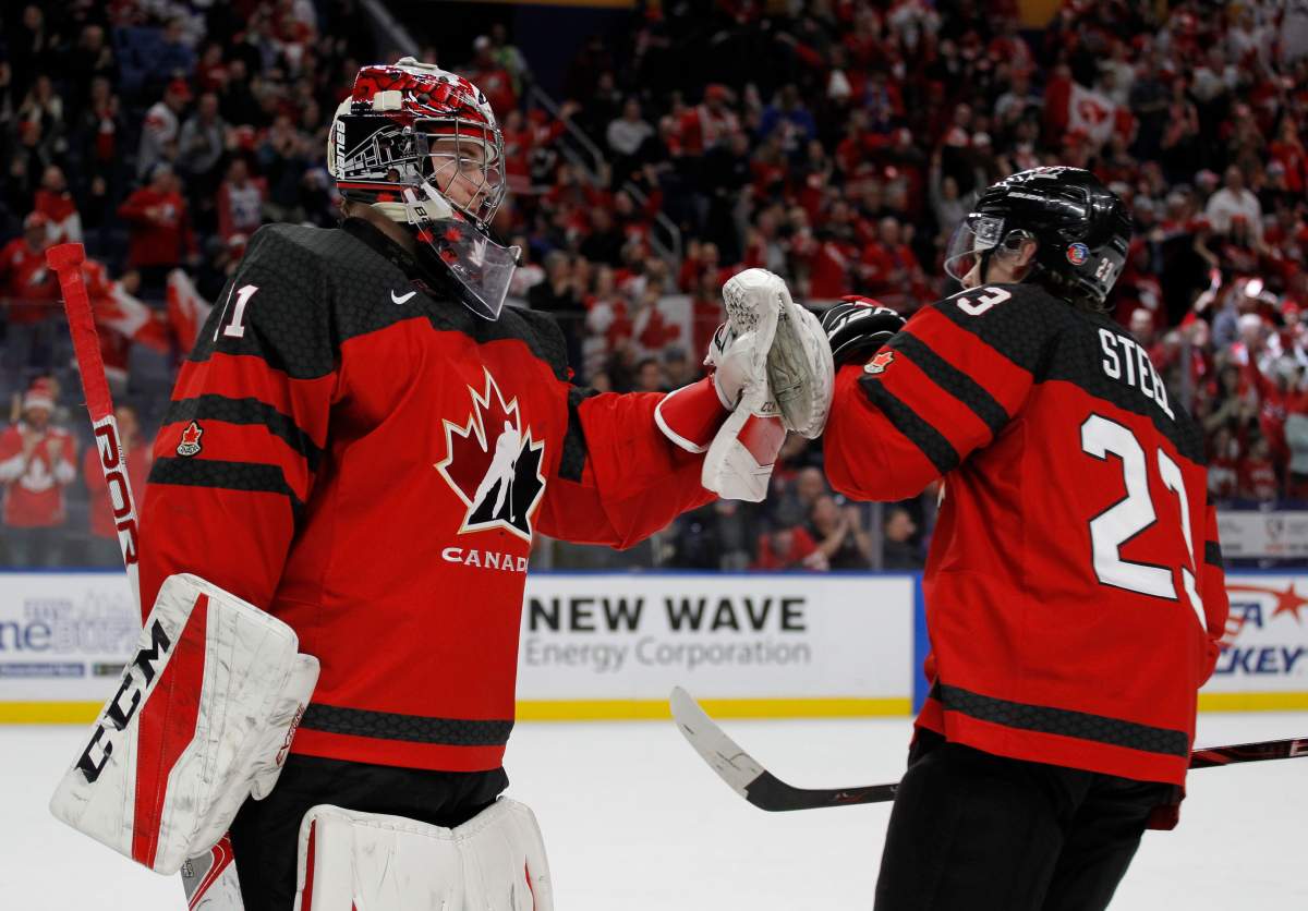 Canada Ggoalie Carter Hart (31) and forward Sam Steel (21) celebrate a goal during the first period against the Czech Republic in a semifinal in the IIHF world junior hockey championships Thursday, Jan. 4, 2018, in Buffalo, N.Y. (AP Photo/Jeffrey T. Barnes)
