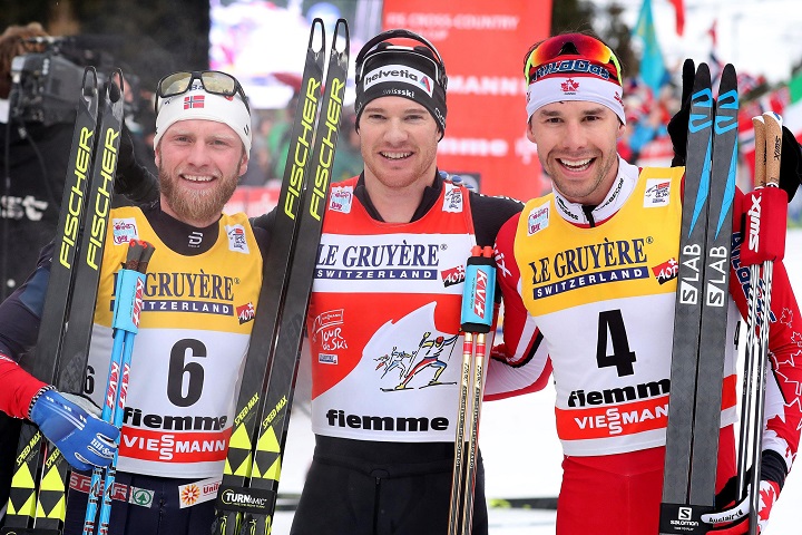  Winner Dario Cologna (C) of Switzerland with second placed Martin Johnsrud Sundby (L) of Norway and third placed Alex Harvey (R) of Canada celebrate in the finish area after the men's 9 km Final Climb Pursuit race at the FIS Tour de Ski event in Val di Fiemme, Italy, Sunday, Jan. 7, 2018. 