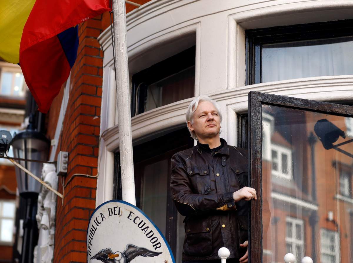 In this May 19, 2017 file photo, WikiLeaks founder Julian Assange greets supporters outside the Ecuadorian embassy in London.