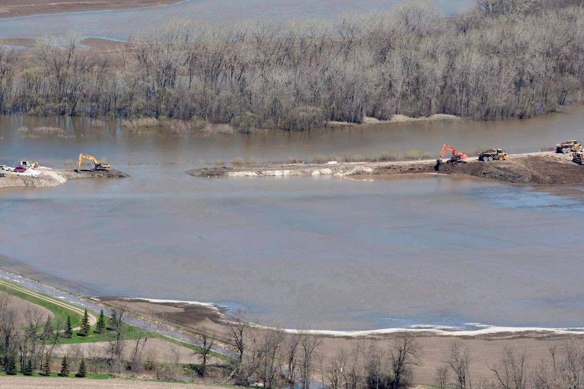 The breach in the dike at the hoop and holler bend is seen along the Assiniboine River outside of Portage La Prairie, Man, Saturday, May 14, 2011. A settlement approval hearing is scheduled for a $90-million settlement stemming from a class action lawsuit launched by Lake St. Martin, Pinaymootang (Fairford), Little Saskatchewan and Dauphin River First Nations against the federal and provincial governments over 2011 flooding. THE CANADIAN PRESS/Jonathan Hayward