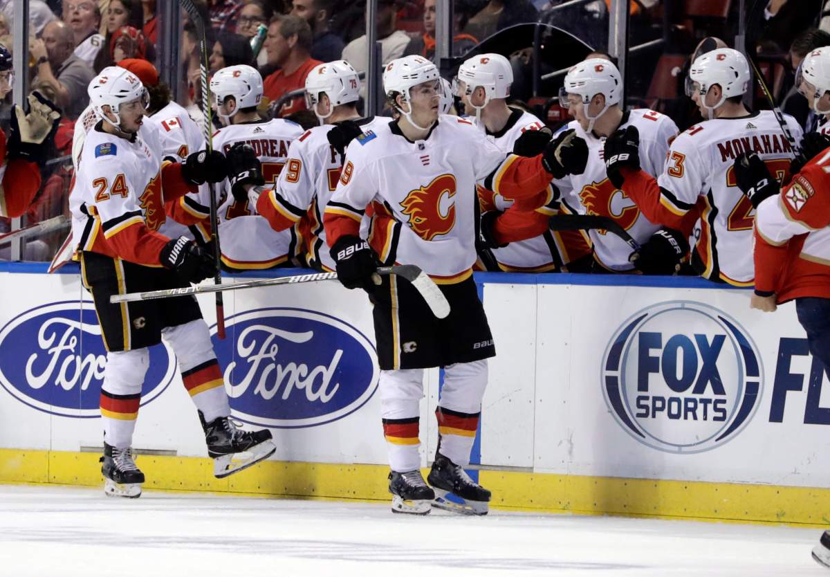 Calgary Flames' Matthew Tkachuk (19) is congratulated after scoring a goal during the second period of the team's NHL hockey game against the Florida Panthers, Friday, Jan. 12, 2018, in Sunrise, Fla. 