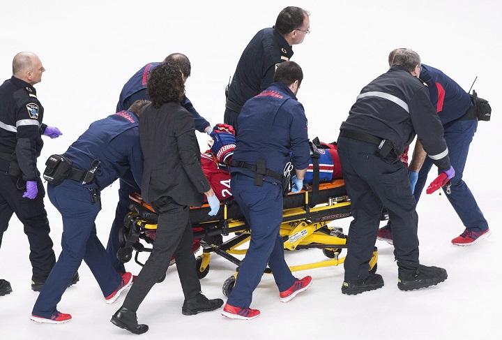 Montreal Canadiens' Phillip Danault is stretchered off the ice after he was hit in the head by a puck on a shot by Boston Bruins' Zdeno Chara during second period NHL hockey action in Montreal, Saturday, January 13, 2018. 