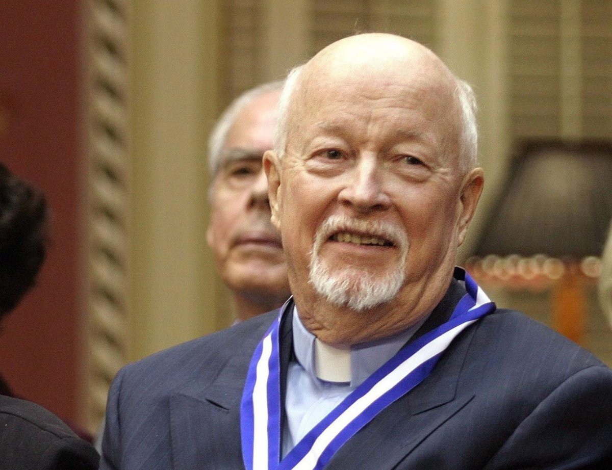 Father Emmett Johns, known as Pops in Montreal, smiles at the end of a ceremony where he was decorated with the Ordre National du Quebec as a Grand Officer, on Tuesday, Oct. 28, 2003, at the Quebec Legislature. A vigil we be held in his memory at Place Émilie-Gamelin on Wednesday, Jan. 17.