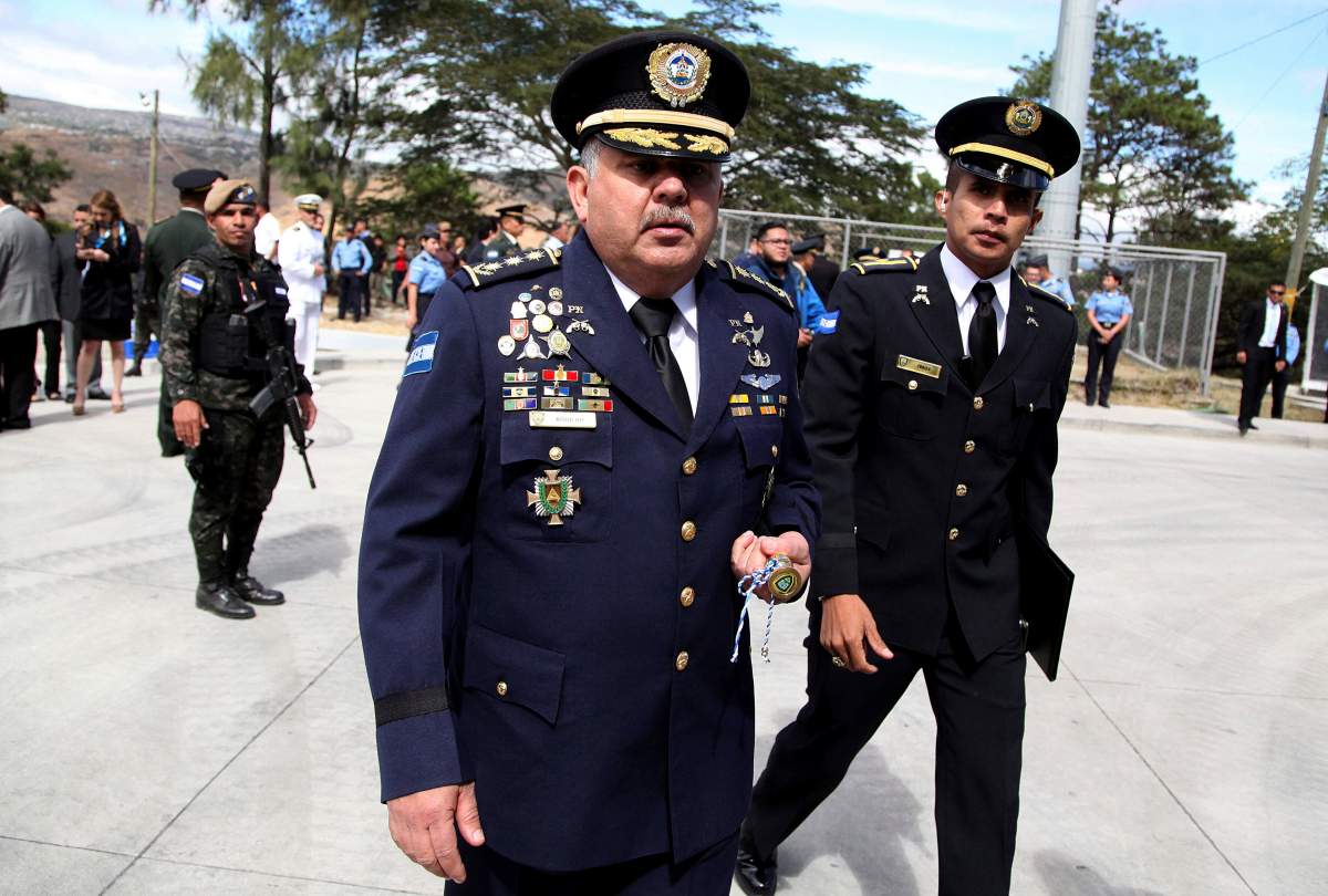 In this Jan. 15, 2018 photo, Honduras' new national Police Chief Jose David Aguilar Moran, center, leaves after a ceremony that transferred command to him in Tegucigalpa, Honduras.