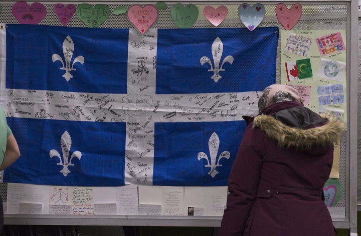 A woman looks at messages of sympathy during a gathering at the Centre Islamique de Quebec, marking the first anniversary of the mosque shooting, Saturday, January 27, 2018 in Quebec City. 
