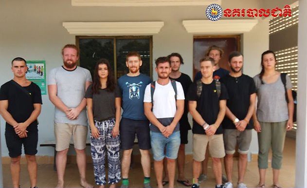 In this photo dated Jan. 27, 2018, issued by Cambodian National Police, a group of foreigners stand after they were arrested for “dancing pornographically” at a party in Siem Reap town, near the country’s famed Angkor Wat temple complex.