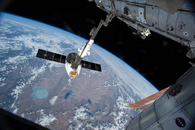 The Canadarm 2 reaches out to capture the SpaceX Dragon cargo spacecraft and prepare it to be pulled into its port on the International Space Station on April 17, 2015. T

.