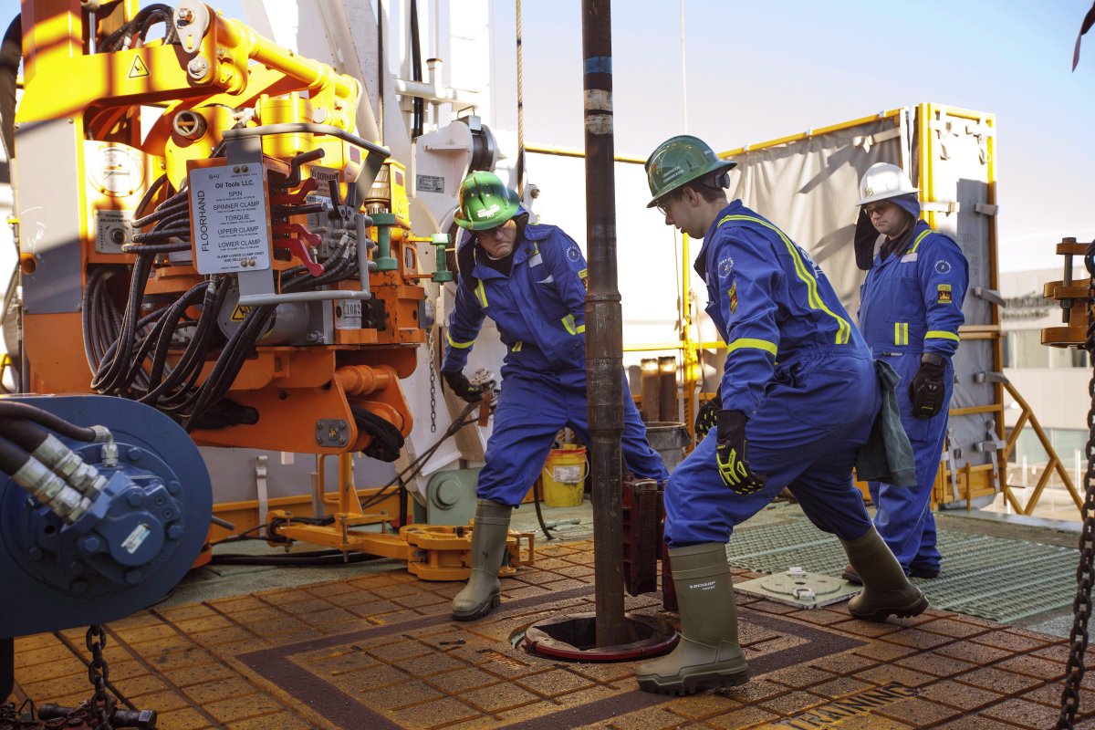 FILE: Trainees being directed by instructor while training to lay down drill pipe on a rig floor, at Precision Drilling in Nisku, Alta., on January 20, 2016.