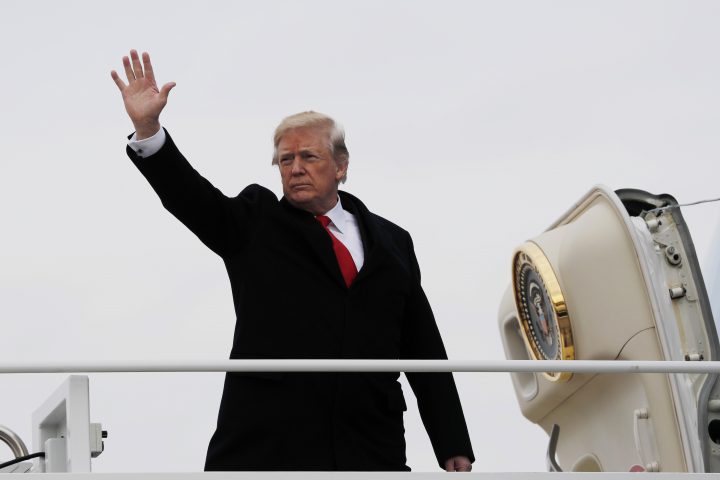 U.S. President Donald Trump waves as he boards Air Force One on Dec. 22, 2017.