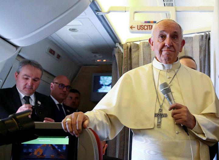 Pope Francis speaks to reporters on board the plane for his trip to Chile and Peru, on Jan. 15, 2018.   