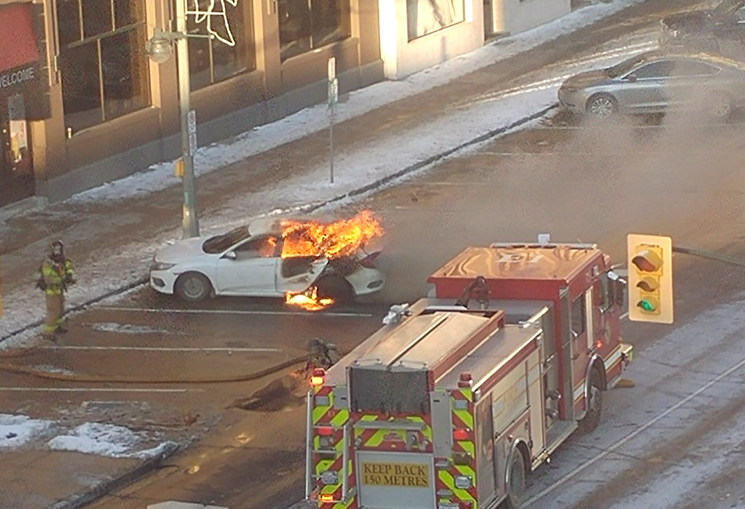Flames tear through the back end of this Honda Civic on Dundas Street. 