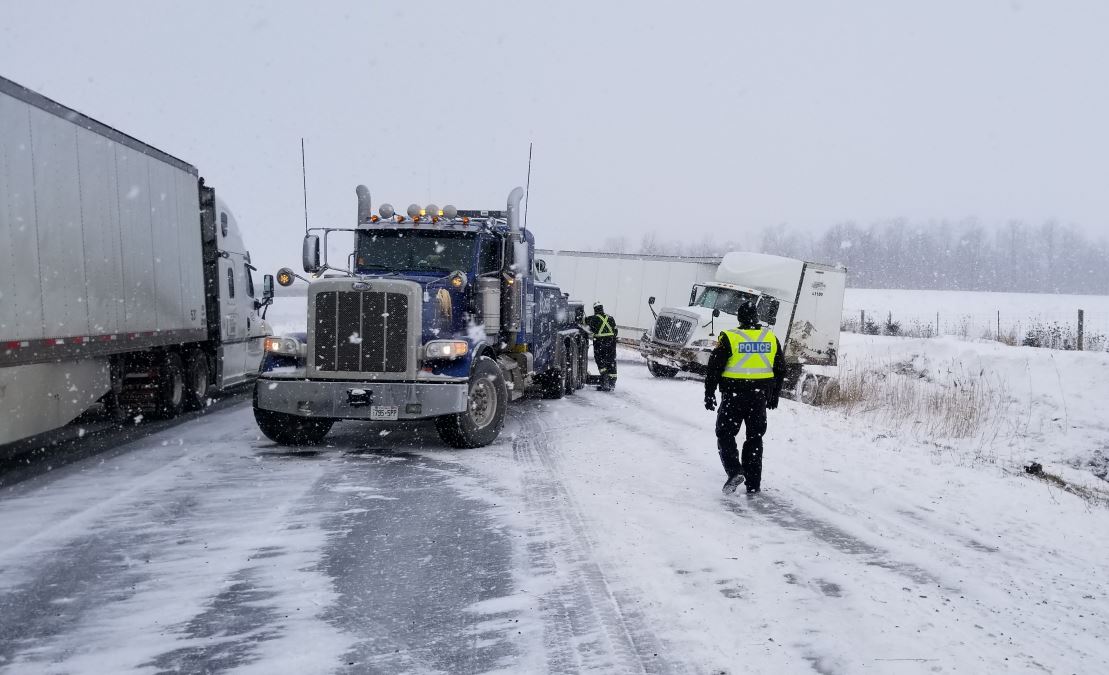 A tractor trailer can be seen in the ditch along the 402 near Centre Road on Jan. 30, 2018 in this photo provided by provincial police. The incident was one of dozens emergency crews had to tend to throughout the day.