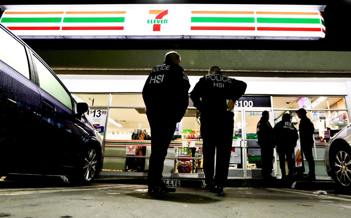 U.S. Immigration and Customs Enforcement agents serve an employment audit notice at a 7-Eleven convenience store Wednesday, Jan. 10, 2018, in Los Angeles. 