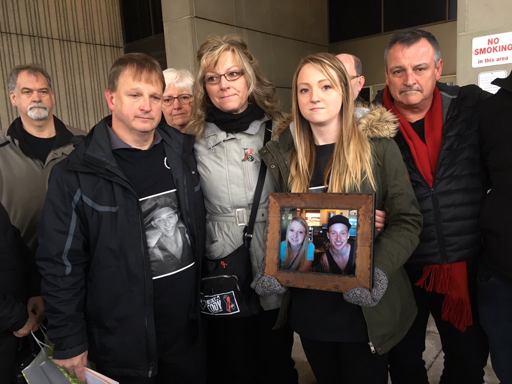 Cody Andrews' family stands outside the courthouse Jan 18, 2017. His sister, Sarah, holds a photo, standing next to her mom, Shauna Andrews, and her dad, Dave Andrews. 