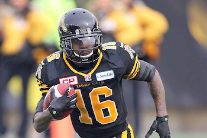 HAMILTON, ON - NOVEMBER 23: Brandon Banks #16 of the Hamilton Tiger-Cats takes off with the ball against the Montreal Alouettes in the CFL football Eastern Conference Final at Tim Hortons Field on November 23, 2014 in Hamilton, Ontario, Canada. 