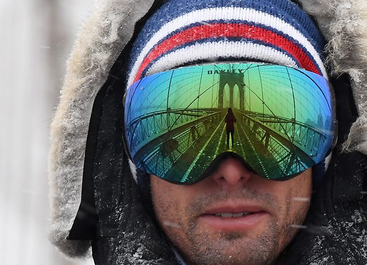 A man wears googles reflecting the Brooklyn Bridge on January 4, 2018 in New York.
