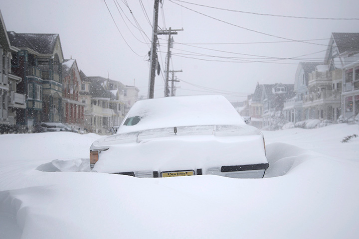 A vehicle is surrounded by snowdrifts near New Jersey Shore on Jan. 4, 2018.